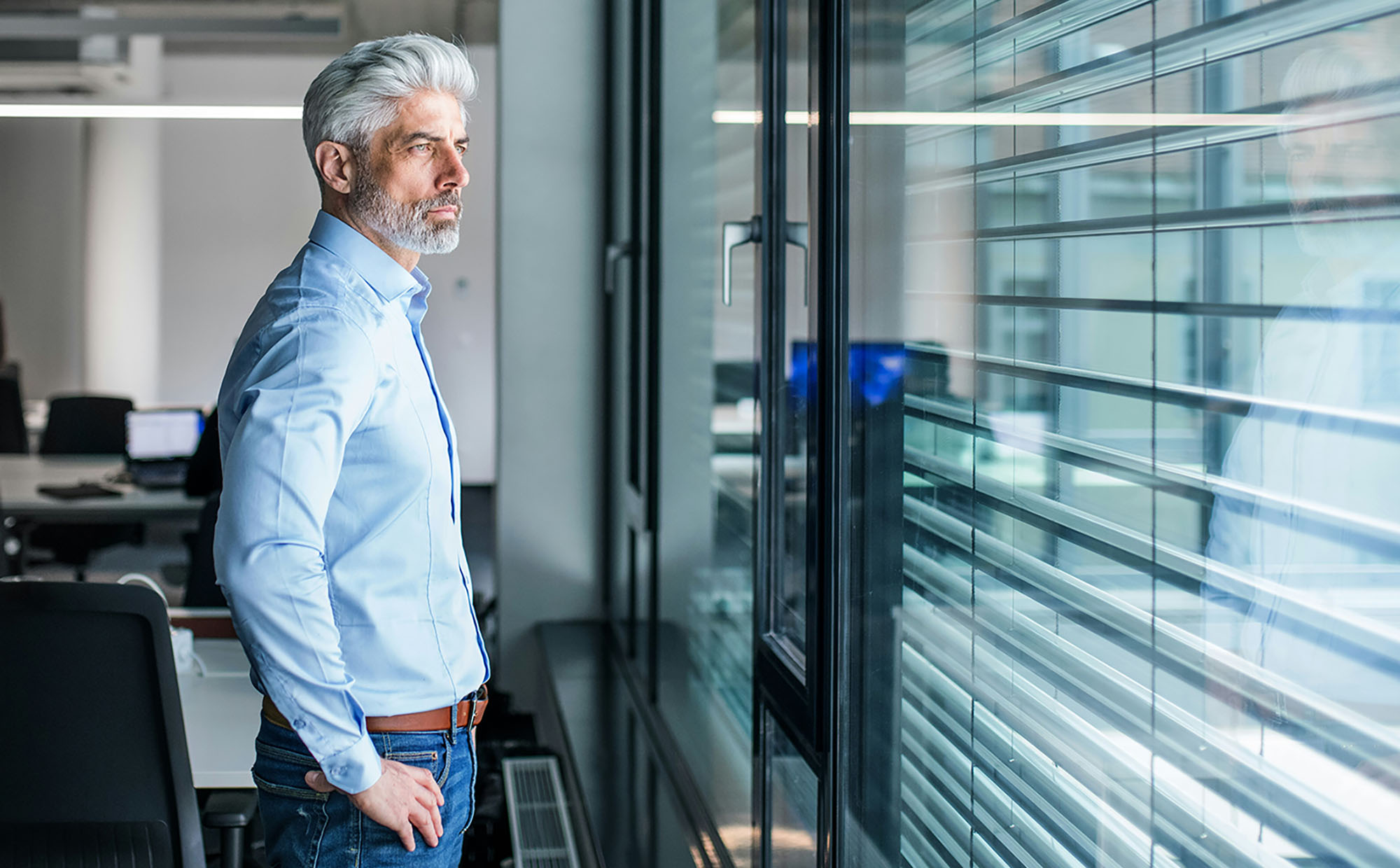 A leader pausing at the window, the organization behind them